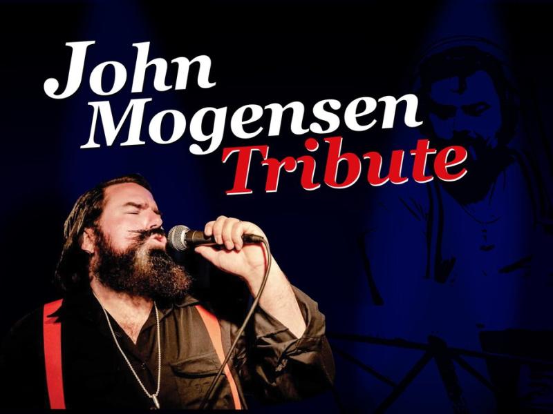 John Mogensen Tribute overskrift og en billede af sangere der synger under. 